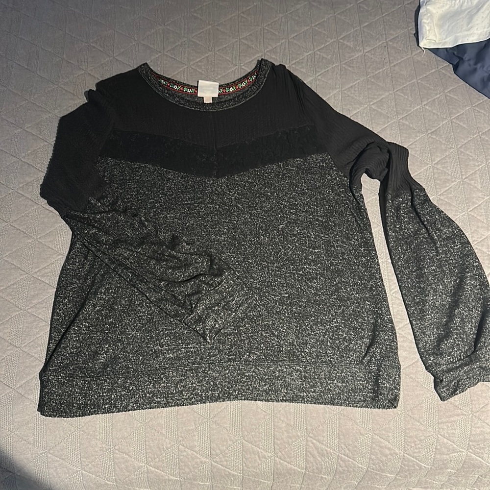 Oversized fit. Adorable w/ leggings/skinny jeans or tucked in to a trouser pant